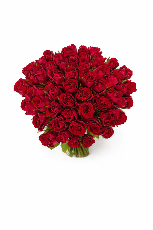 A bouquet of 50 red roses in a clear glass vase, showcasing vibrant blooms and lush green leaves, perfect for romantic occasions.
