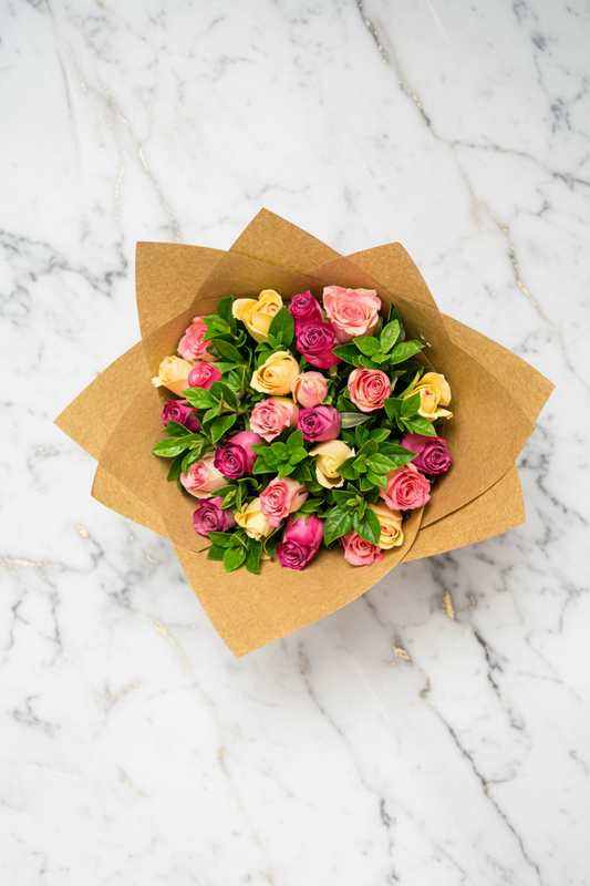 Colorful pastel roses arrangement featuring 24 roses, perfect for home decor or special occasions.
