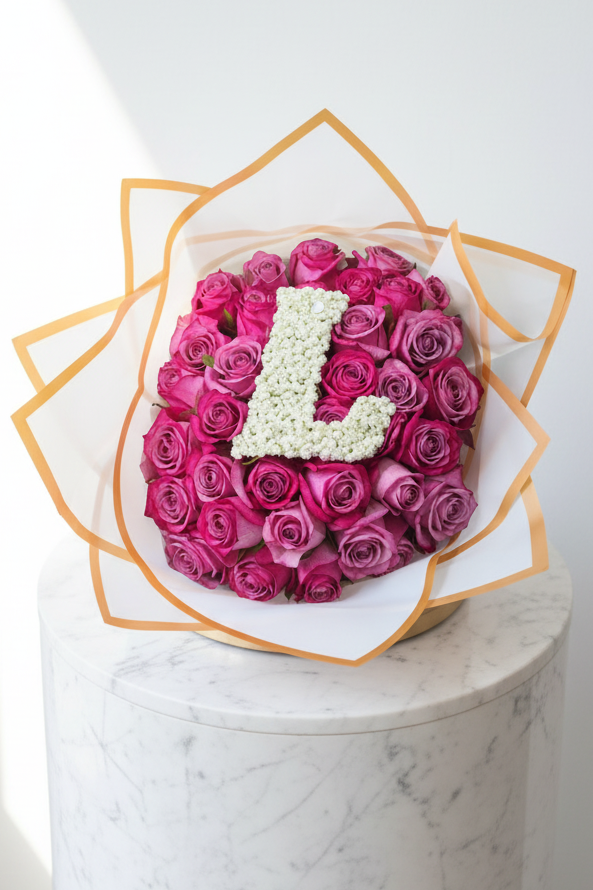 Two-tone purple roses with a single letter, arranged in a bouquet, showcasing vibrant blooms and elegant floral display.