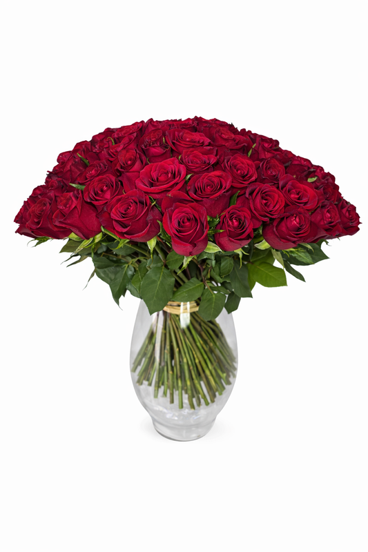 Red roses bouquet with 50 stems in a clear glass vase, featuring vibrant blooms and lush green leaves.