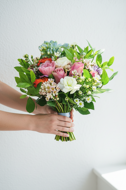 Spring Bliss Bridal Bouquet featuring vibrant pastel roses, lilies, and greenery arranged in a beautiful wedding bouquet.