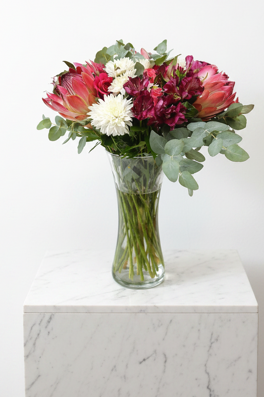 Elegant Perfect Impression Bloom vase with colorful artificial flowers arranged inside, showcasing vibrant floral decor.