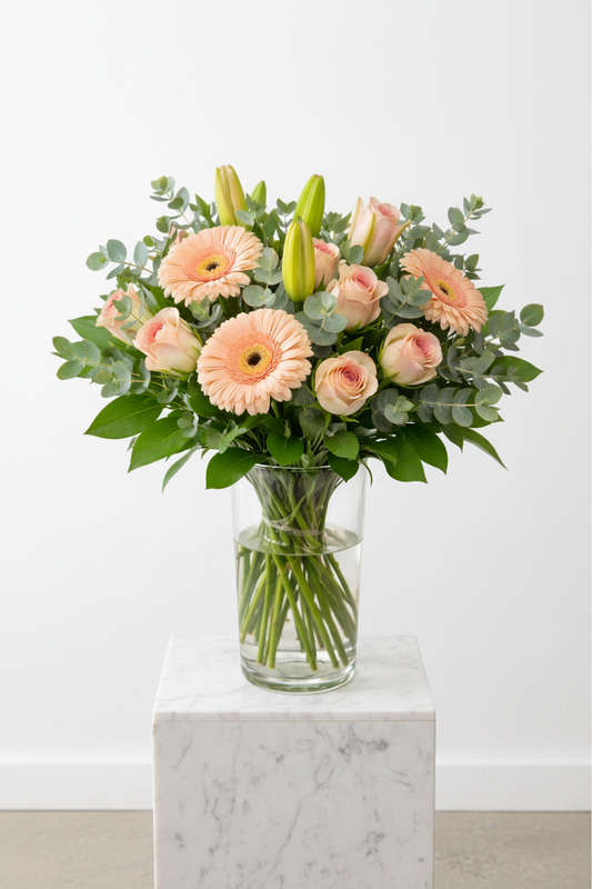 Decorative vase with pastel-colored flowers arrangement in a glass vase, showcasing a soft and elegant floral display.