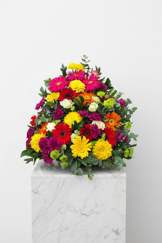 Colorful upright funeral arrangement for sympathy, featuring vibrant flowers in a respectful display.