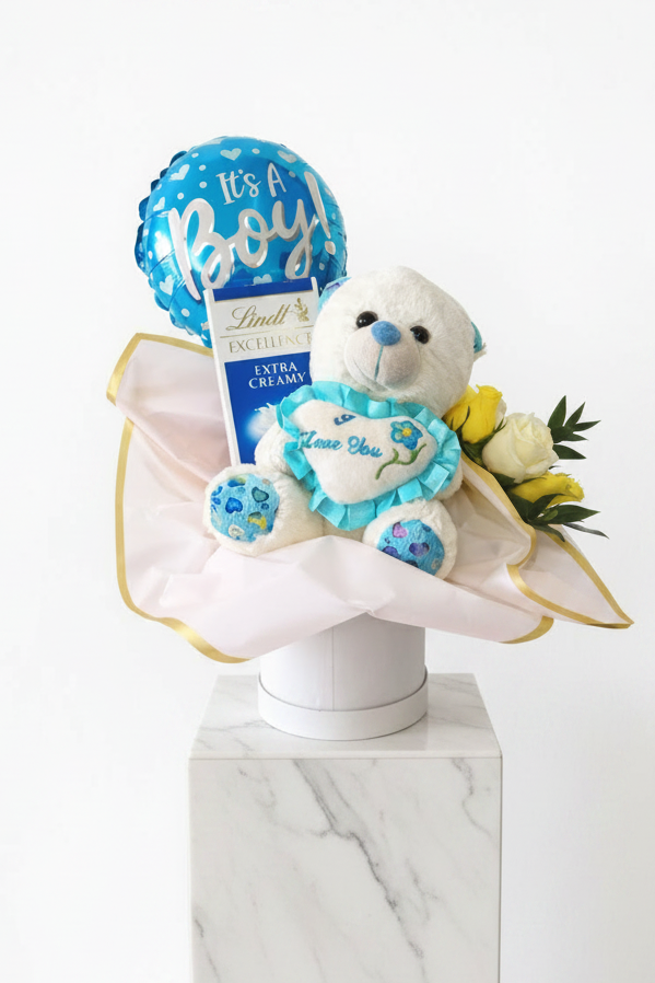 "It's a boy" gift set with baby-themed gifts, including a plush toy and decorative items, for celebrating a new arrival.