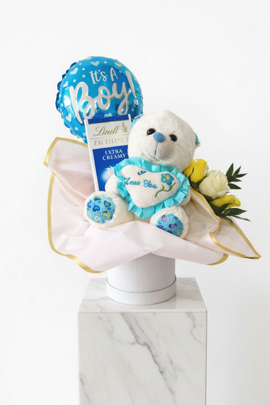 "It's a boy" gift set with baby-themed gifts, including a plush toy and decorative items, for celebrating a new arrival.